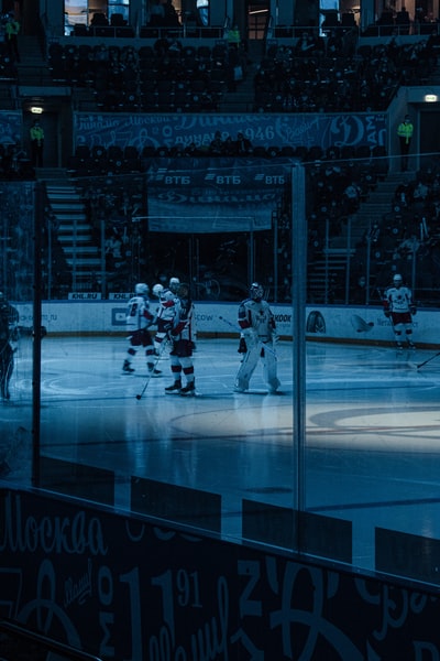 People playing ice hockey stadium on the ice
